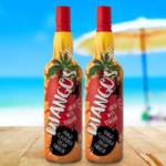 Two bottles of Django Mango Liqueur at the beach
